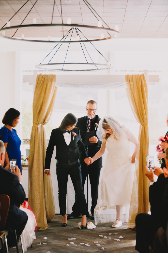 Favorite Southern California LGBTQ Wedding Photographer Moment of two brides breaking glass at jewish wedding